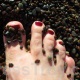 Mistress Troy runs Her feet through the pebbles of a California beach