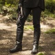 Dominatrix Mistress Troy in 'OWK boots' holding pet's leash, NYC